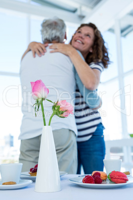 Couple hugging at restaurant