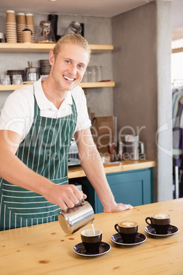 Waiter pouring coffee in a cup