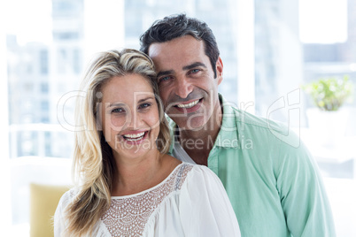 Smiling romantic couple at home