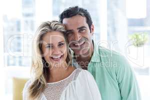 Smiling romantic couple at home