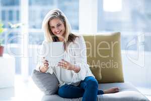 Young woman using digital tablet at home