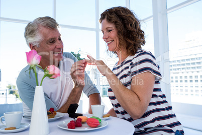 Mature man gifting ring to woman