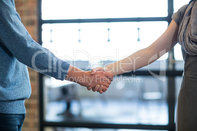 Cropped image of colleagues shaking hands