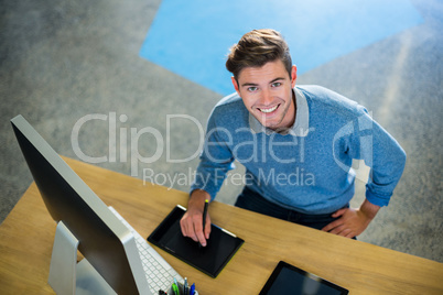 Creative businessman working on graphics tablet