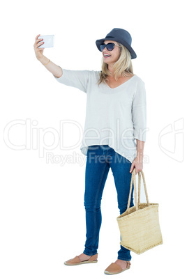 Cheerful mid adult woman taking selfie