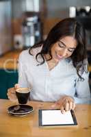 Close-up of businesswoman using digital tablet in cafÃ&#xa9