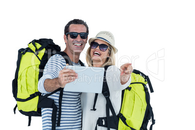 Cheerful couple taking selfie on digital tablet