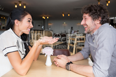 Couple interacting with each other in cafeteria