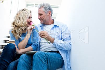Mature man giving rose to woman
