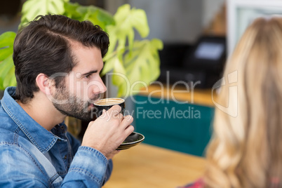 Man drinking cup of coffee in cafe