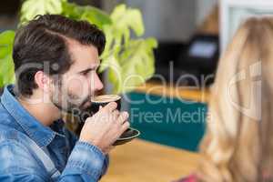 Man drinking cup of coffee in cafe