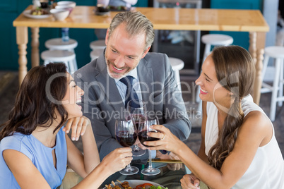 Happy business colleagues toasting wine glass