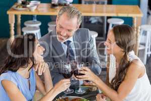 Happy business colleagues toasting wine glass