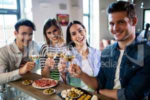 Friends enjoying wine and food at counter