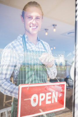 Waiter holding open signboard