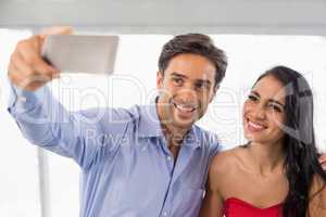 Couple taking a selfie in cafe