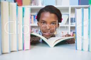 Schoolgirl reading book in library