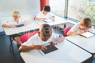 Schoolkids using digital tablets in classroom