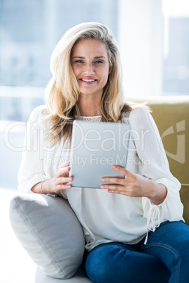 Woman holding digital tablet at home