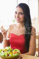 Beautiful woman having champagne with food salad