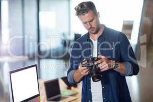 Focused man holding camera