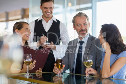 Waiter taking the order from a businessman and his colleagues