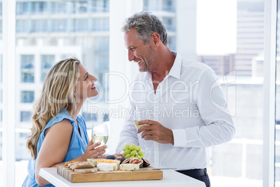 Happy mature couple toasting white wine