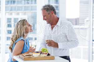 Happy mature couple toasting white wine