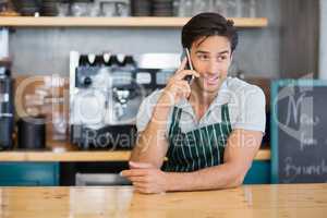 Waiter talking on mobile phone