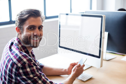 Businessman using mobile phone in office