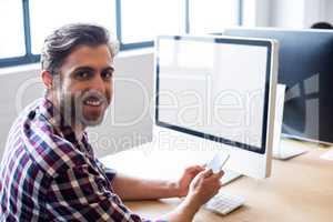 Businessman using mobile phone in office