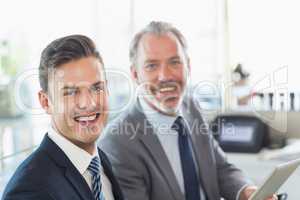 Portrait of businessmen holding digital tablet