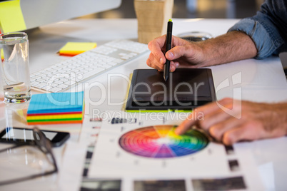 Businessman using graphics tablet in office