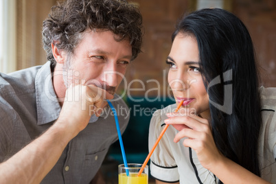 Couple having juice in cafeteria