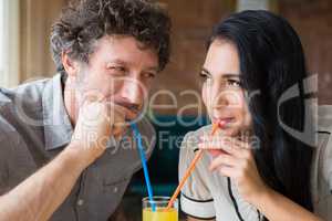 Couple having juice in cafeteria