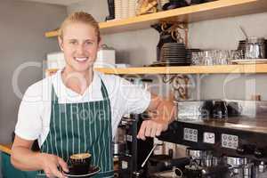 Waiter holding a cup of coffee