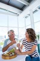 Smiling mature couple sitting at restaurant