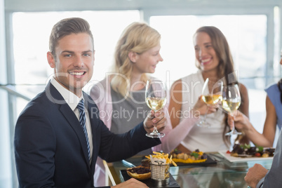 Portrait of businessman having lunch which his colleagues