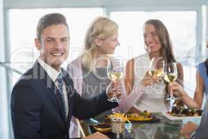 Portrait of businessman having lunch which his colleagues