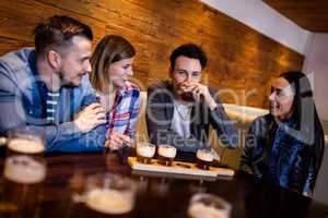 Friends having beer at table in restaurant