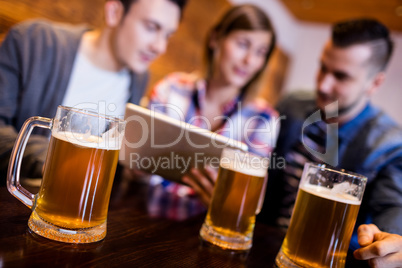 Beer mugs with friends at restaurant