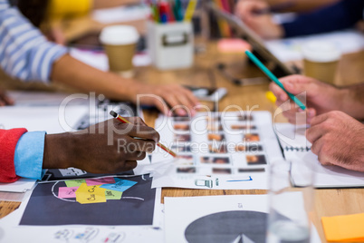 Cropped image of creative colleagues discussing in meeting