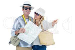 Happy couple pointing while holding map