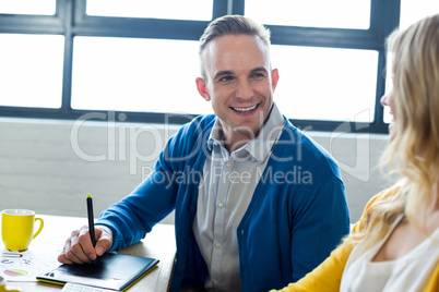 Smiling colleagues talking in office