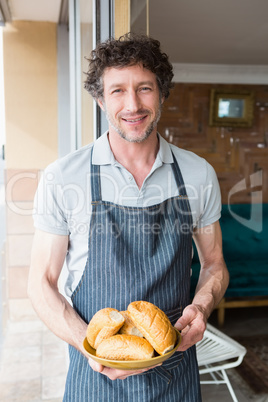 Waiter holding bowl with bread