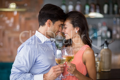 Romantic young couple toasting wine glasses