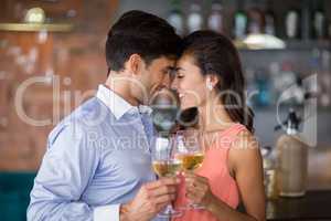 Romantic young couple toasting wine glasses