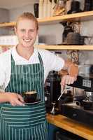Waiter holding a cup of coffee