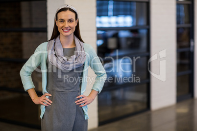 Smiling businesswoman standing in office