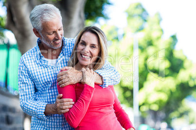 Romantic mature couple against tree